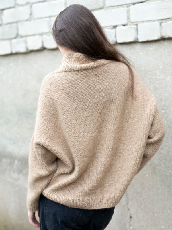 Back view of beige Ruke Classic sweater showing smooth knit and cozy mock neck