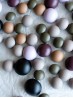 Top view of domed metal buttons in lavender, plum, olive, sand, stone beige and matte black