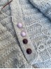 Lavender mist and plum wine matte metal buttons on a grey hand knitted cardigan