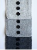 Ruke black 28 mm four-hole bioresin buttons on grey knitted swatches