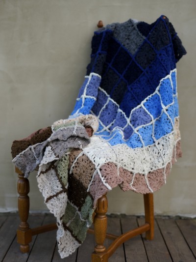 Grandma’s Crocheted Blanket crochet pattern displayed on a wooden chair by Ruke Knit