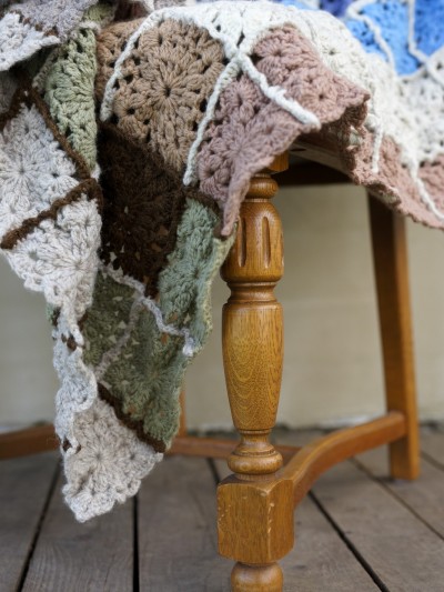 Grandma’s Crocheted Blanket crochet pattern draped detail on wooden chair with joined squares