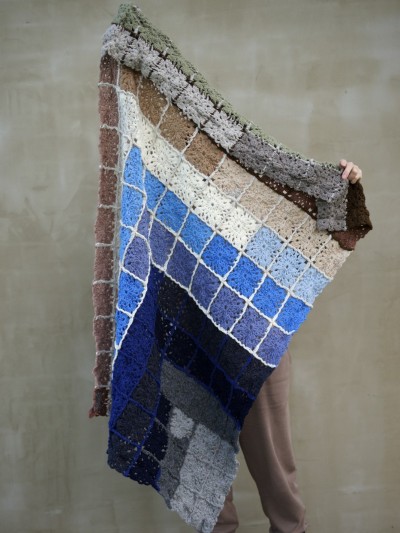 Grandma’s Crocheted Blanket crochet pattern shown as model holding the handmade blanket