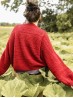 Back view of the red Ruke Moon cardigan knitting pattern with textured stitch panels
