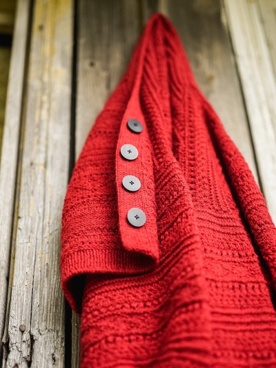 Red Ruke Moon cardigan knitting pattern button band detail on wooden wall