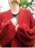 Close-up of the red Ruke Moon cardigan knitting pattern front texture and sleeves