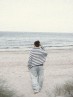 Marine sweater knitting pattern by Ruke Knit - oversized striped sweater back view by the sea