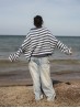 Marine sweater knitting pattern by Ruke Knit - oversized striped sweater back view on the beach