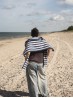 Marine sweater knitting pattern by Ruke Knit - relaxed striped sweater back view on sandy beach