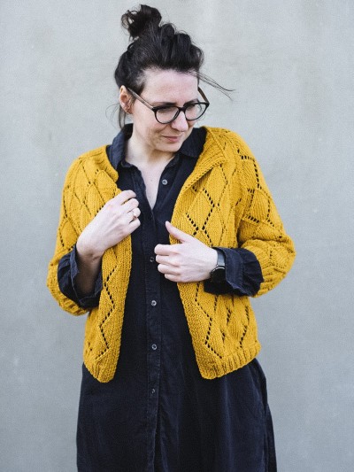 Model wearing the yellow Diamond Cardigan knitting pattern by Ruke Knit