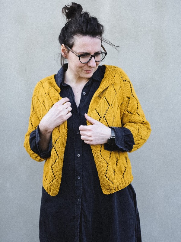 Model wearing the yellow Diamond Cardigan knitting pattern by Ruke Knit